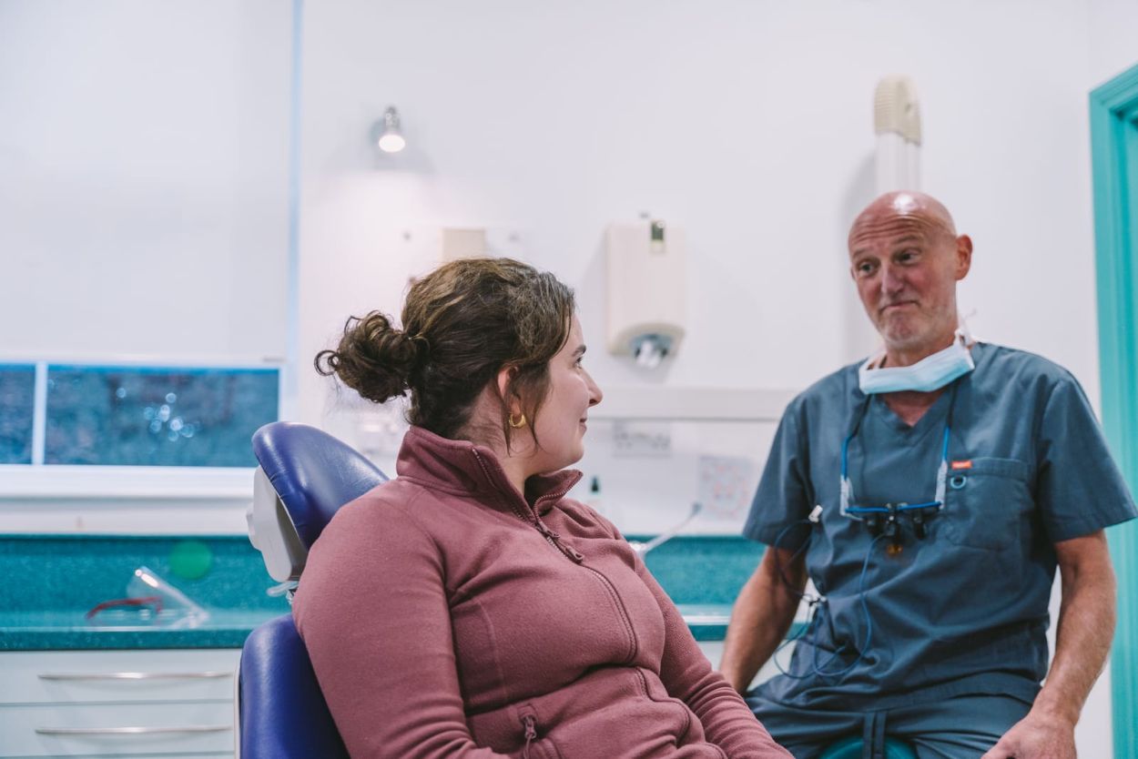Dentist at Titchfield Dental Health talking with a patient in the dental chair